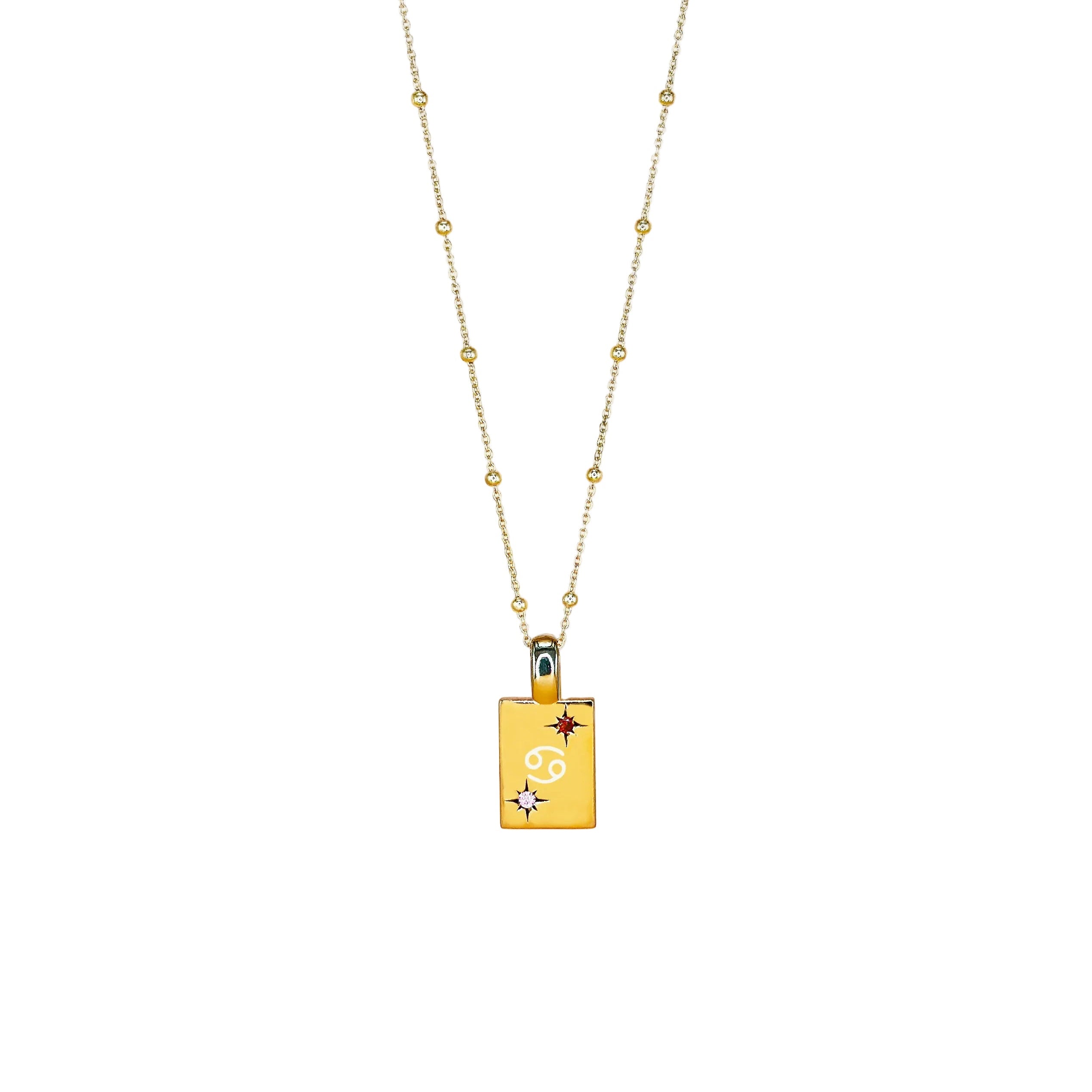 A gold-colored necklace with a pendant featuring the Cancer zodiac sign and a yellow chain.
