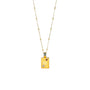 A gold-colored necklace with a pendant featuring the Cancer zodiac sign and a yellow chain.