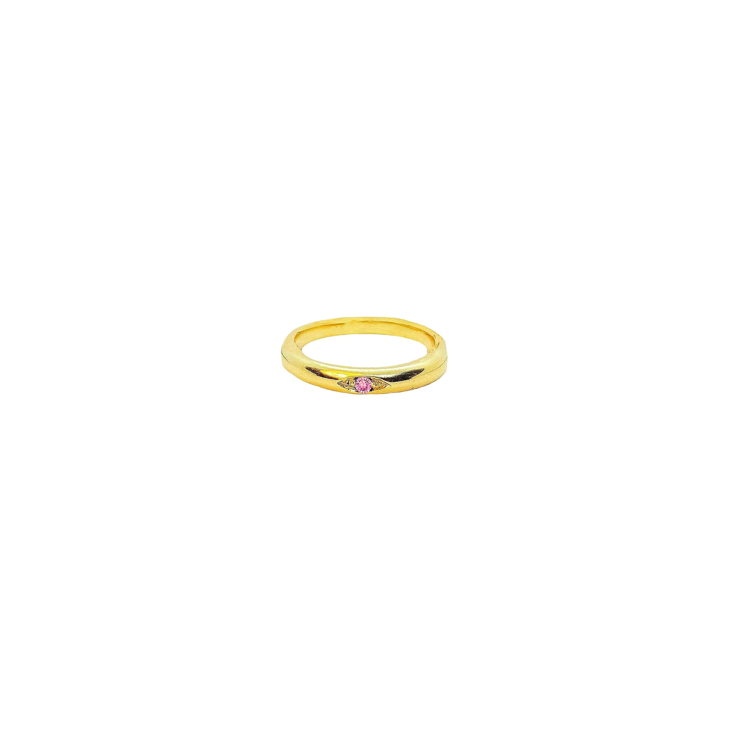 Gold ring with a small pink gemstone on a white background