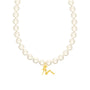 Pearl necklace with a gold charm on a white background