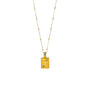 A gold-colored necklace featuring a rectangular pendant with the Gemini zodiac symbol and birthstones represented by green and purplish pink zirconia stones.