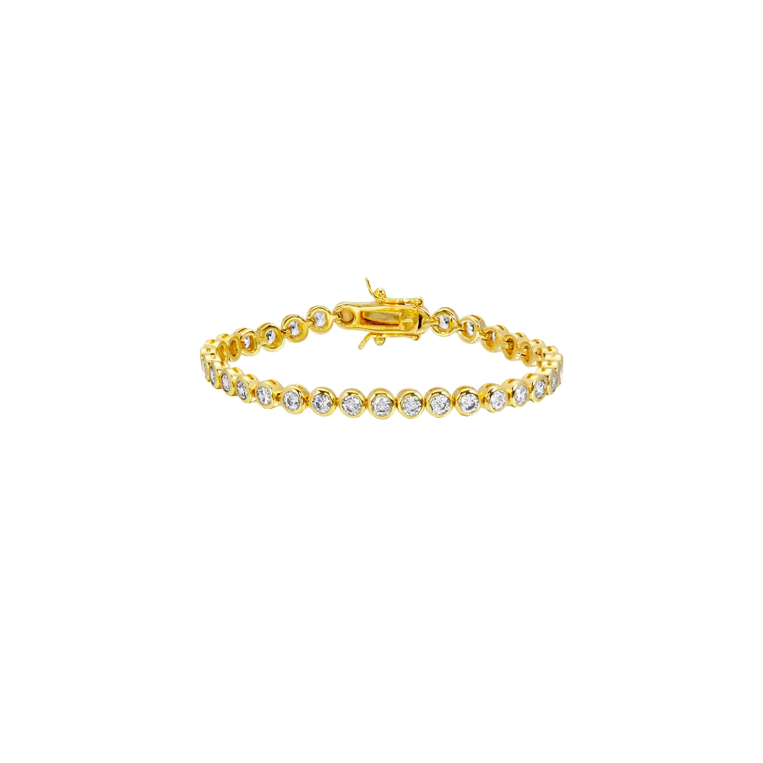 Gold bracelet with clear stones on a beige background