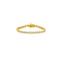 Gold bracelet with clear stones on a beige background