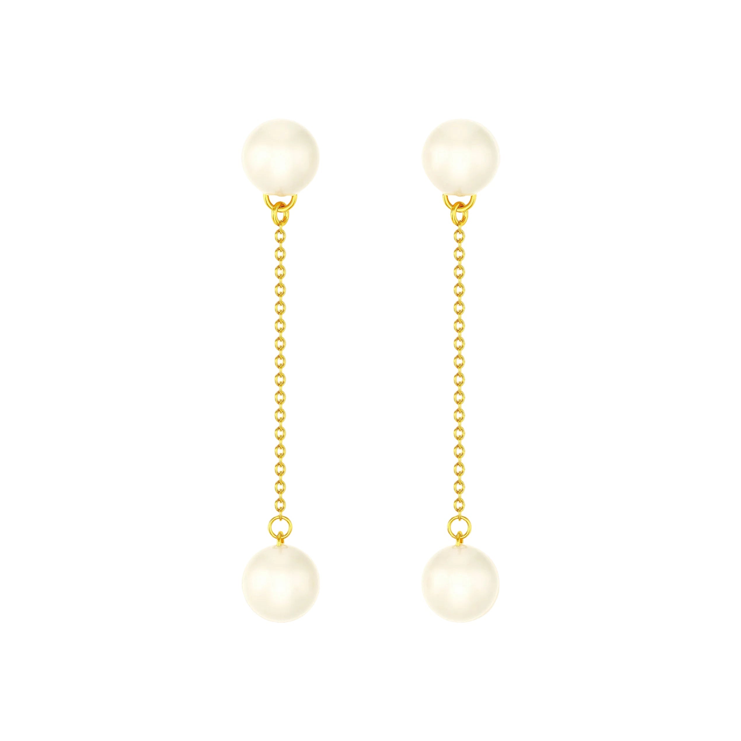 Pair of pearl earrings with gold chains on a white background