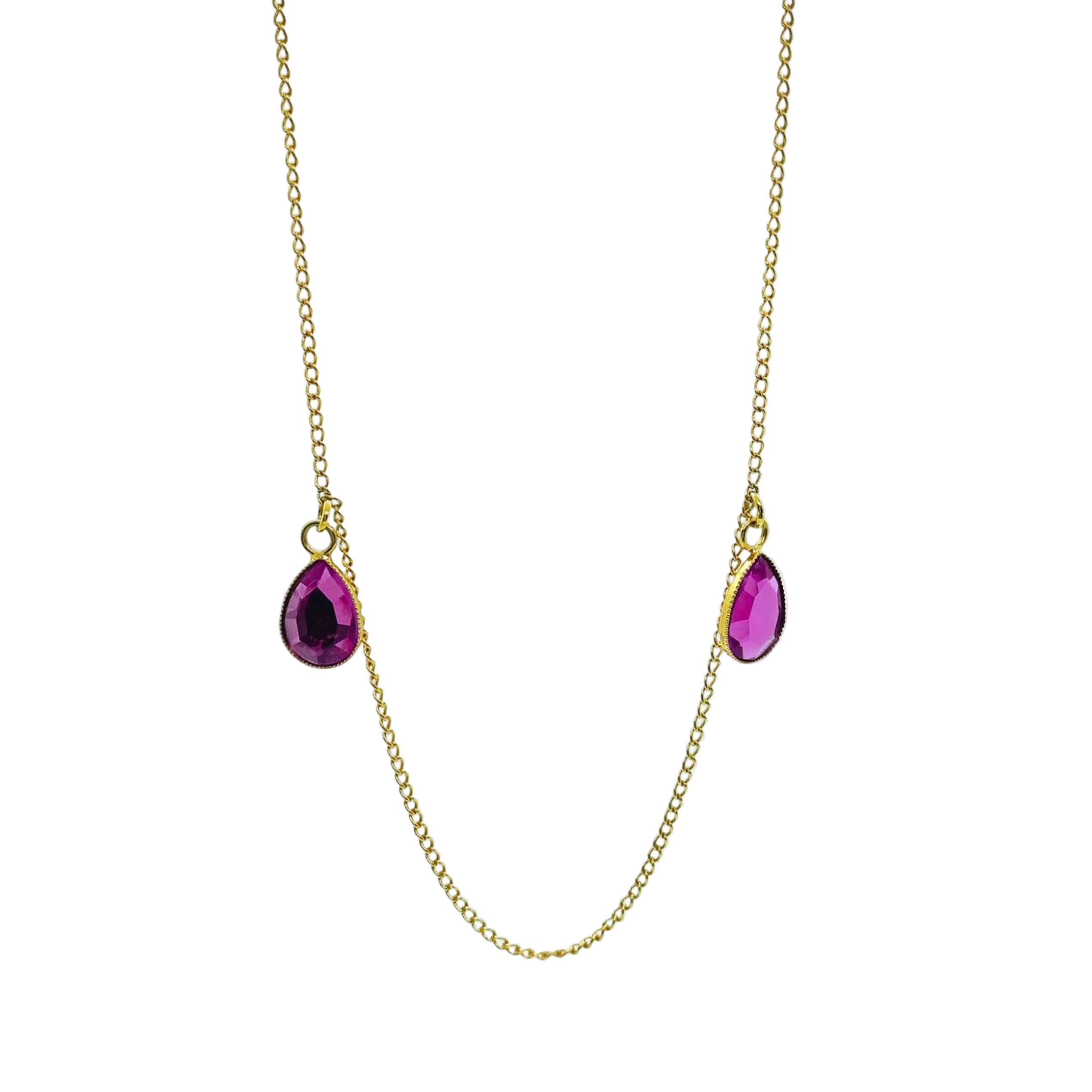Gold necklace with two purple teardrop-shaped gemstones on a white background