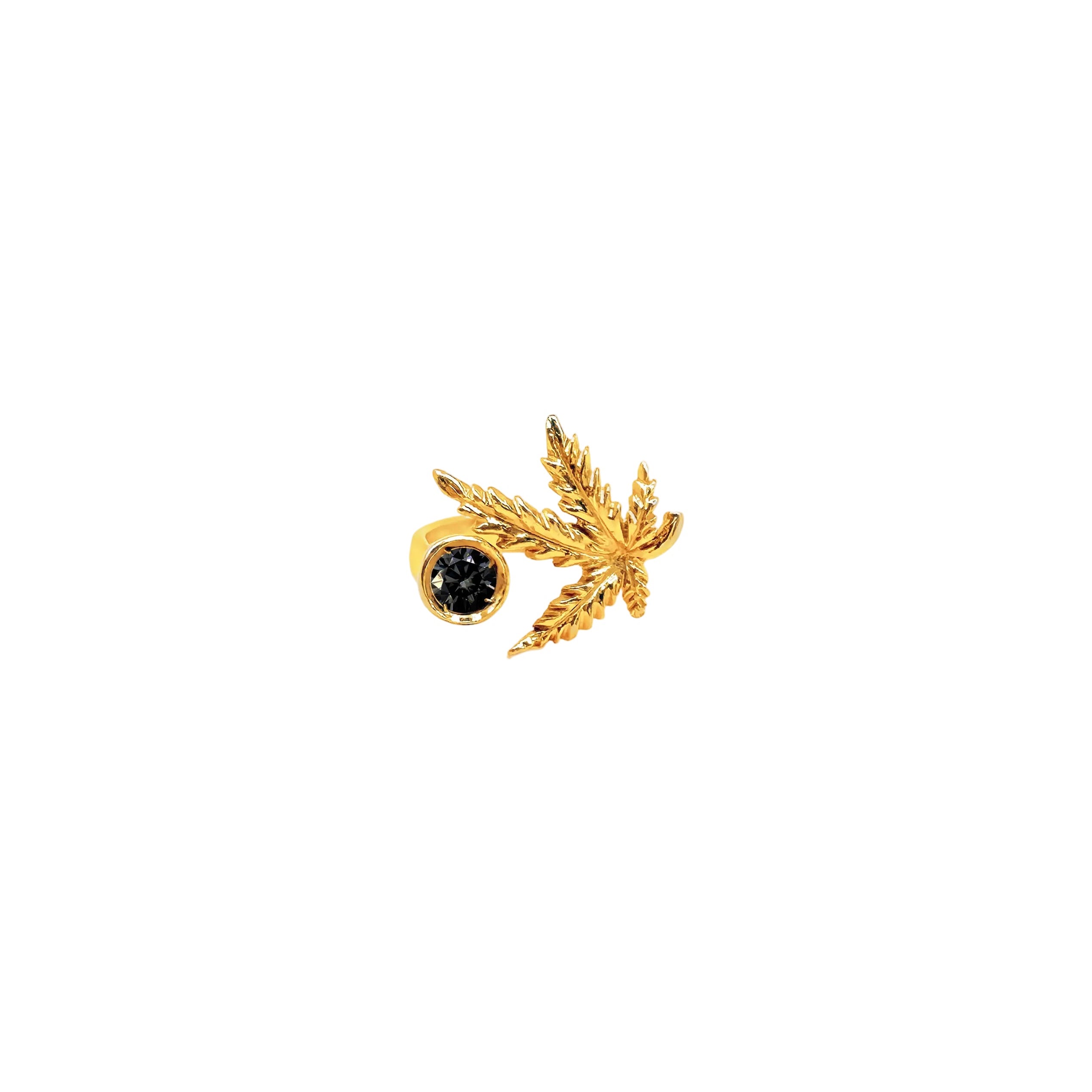 Gold leaf-shaped earring with a black gemstone on a white background