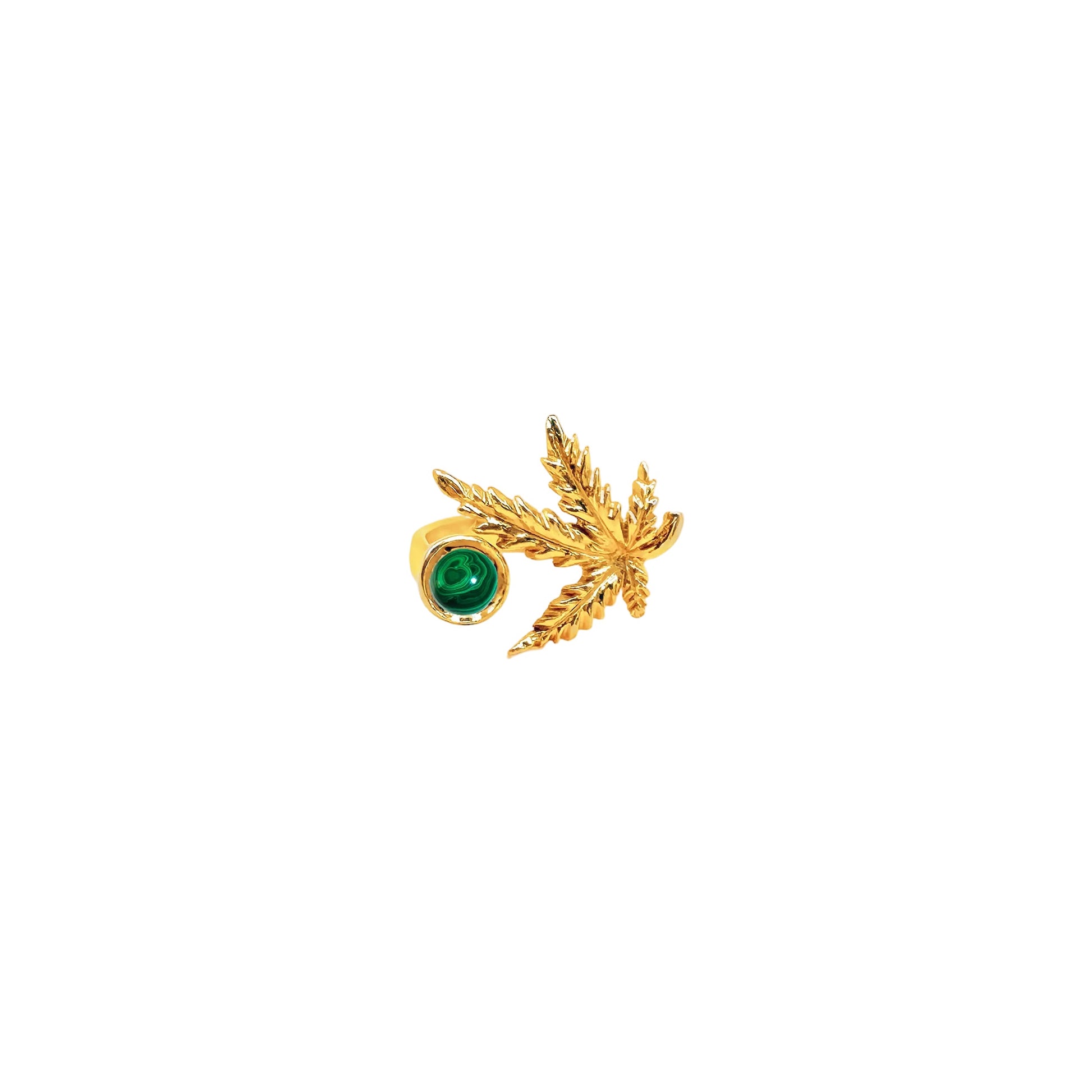 Gold earring with green gemstone on a white background