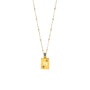 Gold necklace with a rectangular pendant on a white background