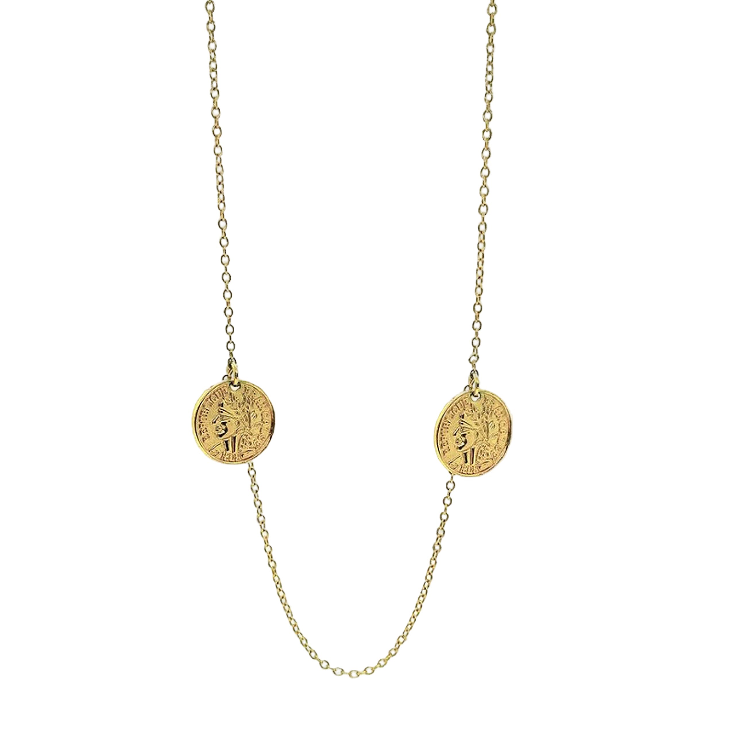 Gold necklace with two round pendants on a white background