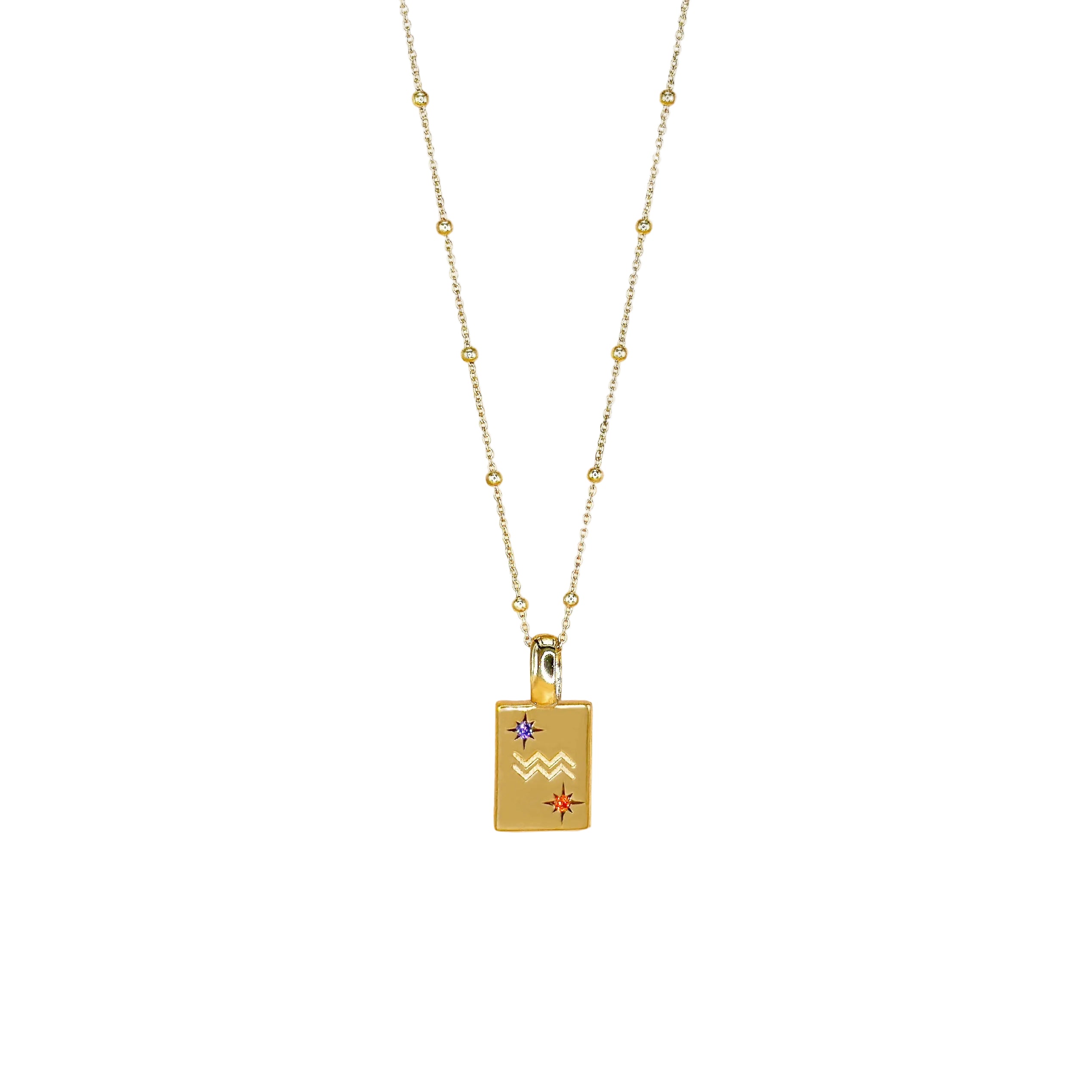 Gold necklace with a rectangular pendant featuring star and moon designs on a white background