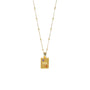 Gold necklace with a rectangular pendant featuring star and moon designs on a white background
